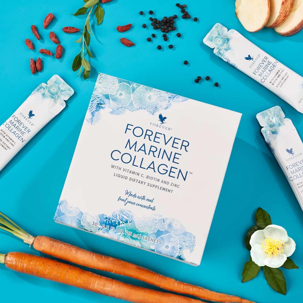 Forever Marine Collagen packaging on a blue background with carrots and other items.